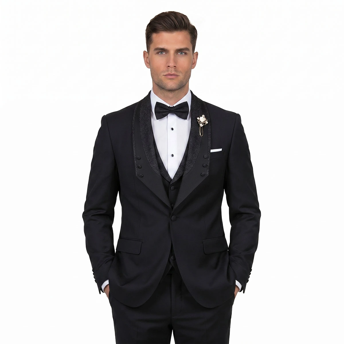 Men’s custom black tuxedo with glitter lapel, matching vest, white dress shirt, black bow tie, pocket square, and lapel pin by Andre Emilio