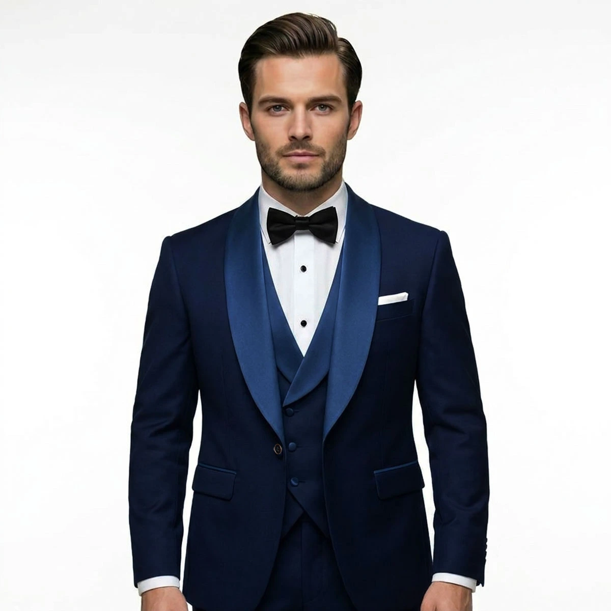Men’s navy blue tuxedo with blue satin shawl lapel, matching vest, white dress shirt, black bow tie, and pocket square by Andre Emilio